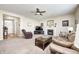 Cozy living room features a ceiling fan, neutral carpet, a fireplace, and comfortable seating at 13068 Lamarque Pl, Fishers, IN 46038