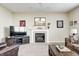 Inviting living room featuring a fireplace, neutral carpet, a ceiling fan, and comfortable leather furnishings at 13068 Lamarque Pl, Fishers, IN 46038