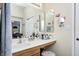 Main bathroom vanity with large mirror, vanity lighting and access to the main bedroom at 13068 Lamarque Pl, Fishers, IN 46038
