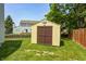 Backyard storage shed with doors that match the exterior's color scheme at 13068 Lamarque Pl, Fishers, IN 46038