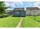 Backyard view of this home with a gray exterior, a manicured lawn, and a concrete walkway to the entry at 1346 W 27Th St, Indianapolis, IN 46208