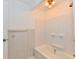 Bright bathroom featuring a white tub and shower with ceramic tile and updated fixtures at 1346 W 27Th St, Indianapolis, IN 46208