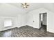 Bright bedroom featuring hardwood floors, neutral walls, ceiling fan, and access to an attached bathroom at 1346 W 27Th St, Indianapolis, IN 46208