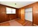 Bedroom with wood paneled walls, wood flooring, a window and closet at 1346 W 27Th St, Indianapolis, IN 46208