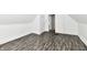 A bedroom showcasing the hardwood floors and neutral walls with access to an attached room at 1346 W 27Th St, Indianapolis, IN 46208