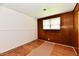 Bright bedroom with hardwood floors, white and wood paneled walls and a window at 1346 W 27Th St, Indianapolis, IN 46208