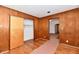Bedroom with hardwood floors and wood paneling features an open closet at 1346 W 27Th St, Indianapolis, IN 46208