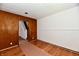 Bedroom with hardwood flooring and wood paneling featuring entry to staircase at 1346 W 27Th St, Indianapolis, IN 46208