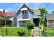Charming two-story home featuring a well-maintained lawn and decorative awnings at 1346 W 27Th St, Indianapolis, IN 46208