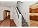 Hallway with staircase featuring carpeted steps and white walls leading to the kitchen at 1346 W 27Th St, Indianapolis, IN 46208