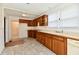 Functional kitchen featuring wood cabinets, neutral countertops, and natural light at 1346 W 27Th St, Indianapolis, IN 46208