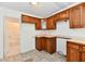 Functional kitchen featuring wood cabinets, neutral countertops, and natural light at 1346 W 27Th St, Indianapolis, IN 46208