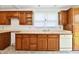 Functional kitchen featuring wood cabinets, neutral countertops, and natural light at 1346 W 27Th St, Indianapolis, IN 46208