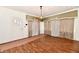 Open living room with hardwood floors, entry door, and decorative window coverings at 1346 W 27Th St, Indianapolis, IN 46208