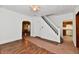 Living room with hardwood floors, white walls, a ceiling fan and view to the stairs at 1346 W 27Th St, Indianapolis, IN 46208