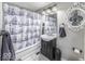 Bathroom features single vanity, tiled floor and shower with ship curtain at 1393 Wayne St, Noblesville, IN 46060