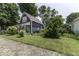Charming home with mature trees, landscaping, and brick-paved driveway at 1393 Wayne St, Noblesville, IN 46060