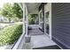 Front porch with white columns, dark siding, and a view of the street at 1393 Wayne St, Noblesville, IN 46060