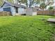 Spacious backyard featuring green grass and a gray shed and garage at 1437 E Pleasant Run Pkwy S Dr, Indianapolis, IN 46203