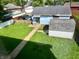 View of a backyard featuring a shed, a fence, a garage, and some grass at 1437 E Pleasant Run Pkwy S Dr, Indianapolis, IN 46203