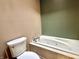 Bathroom with a jacuzzi-style tub set against a wall with a two-tone color scheme at 1437 E Pleasant Run Pkwy S Dr, Indianapolis, IN 46203