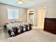 Neutral bedroom featuring a ceiling fan, window, and a large closet, offering ample storage at 1437 E Pleasant Run Pkwy S Dr, Indianapolis, IN 46203