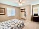 Comfortable bedroom with plush carpet, a queen bed, windows, and a spacious closet at 1437 E Pleasant Run Pkwy S Dr, Indianapolis, IN 46203