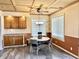 Cozy dining area features wood cabinets, laminate flooring, ceiling fan, and plenty of natural light at 1437 E Pleasant Run Pkwy S Dr, Indianapolis, IN 46203