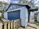 Image features a garage exterior showcasing a garage door, and a fence at 1437 E Pleasant Run Pkwy S Dr, Indianapolis, IN 46203