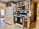 Kitchen featuring wood cabinets, a gas range, and a white refrigerator at 1437 E Pleasant Run Pkwy S Dr, Indianapolis, IN 46203