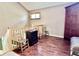 Upstairs landing featuring wood floors, an antique armoire, vintage trunk, and natural light at 1437 E Pleasant Run Pkwy S Dr, Indianapolis, IN 46203