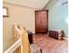 Upstairs landing area featuring wood floors, an antique armoire, and a vintage trunk at 1437 E Pleasant Run Pkwy S Dr, Indianapolis, IN 46203