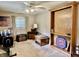 Living room featuring carpeted floor, ceiling fan, and built in wood shelving at 1437 E Pleasant Run Pkwy S Dr, Indianapolis, IN 46203