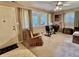 Comfortable living room with a carpeted floor, large windows, and neutral colored walls at 1437 E Pleasant Run Pkwy S Dr, Indianapolis, IN 46203