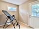 Light-filled room with natural light through windows, featuring an inversion table and a door at 1437 E Pleasant Run Pkwy S Dr, Indianapolis, IN 46203