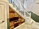 Unique staircase featuring built-in wooden drawers and white railings, maximizing storage space at 1437 E Pleasant Run Pkwy S Dr, Indianapolis, IN 46203