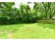 A well-maintained backyard featuring a large lawn, tall trees for privacy and a wooden fence at 1445 Biloxi Ln, Beech Grove, IN 46107