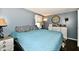 Relaxing bedroom featuring hardwood floors, comfortable bedding and a decorative tree of life wall hanging at 1445 Biloxi Ln, Beech Grove, IN 46107