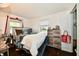 Bright bedroom features comfortable bedding, hardwood floors and large window with backyard view at 1445 Biloxi Ln, Beech Grove, IN 46107