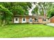 Charming brick home with a well-maintained front yard and lush greenery at 1445 Biloxi Ln, Beech Grove, IN 46107