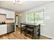 Bright kitchen features stainless steel appliances, a table with seating, and a window overlooking the backyard at 1445 Biloxi Ln, Beech Grove, IN 46107