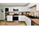 Modern kitchen with stainless steel appliances, white cabinetry, and wood countertops at 1445 Biloxi Ln, Beech Grove, IN 46107