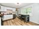Bright kitchen featuring white cabinets, stainless steel appliances, and a dining area at 1445 Biloxi Ln, Beech Grove, IN 46107