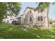 This home features a backyard with a deck, green grass, and mature trees at 15201 Slateford Rd, Noblesville, IN 46062