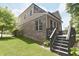 A backyard view of the home showing the deck, yard, and exterior stairs at 15201 Slateford Rd, Noblesville, IN 46062