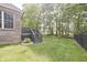 This backyard features a grey deck, green grass and lush trees at 15201 Slateford Rd, Noblesville, IN 46062