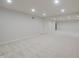 Large finished basement featuring neutral carpet, recessed lighting, and multiple doors at 15201 Slateford Rd, Noblesville, IN 46062