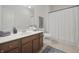 Well-lit bathroom with a modern vanity, shower-tub combination, and neutral tile flooring at 15201 Slateford Rd, Noblesville, IN 46062