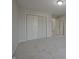 Carpeted bedroom with closet and open doorway, and neutral colored walls at 15201 Slateford Rd, Noblesville, IN 46062