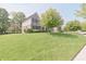 Charming two-story brick home featuring a well-manicured lawn and mature landscaping at 15201 Slateford Rd, Noblesville, IN 46062
